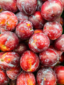 fresh ripe plums as background