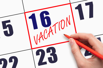 16th day of the month. Hand writing text VACATION on calendar date.