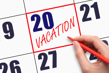 20th day of the month. Hand writing text VACATION on calendar date.