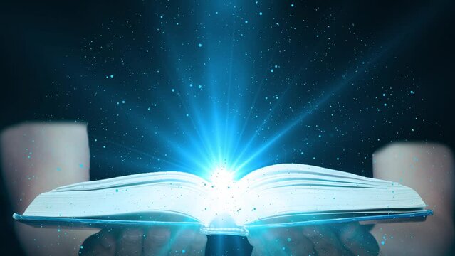 Magic Book on Magician Hand I Dark Background with Glowing Light Rays. The Fairy Tales and Magical Knowledge Concept 