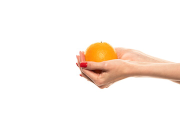 The girl's hand holds a cut round slice of fresh tropical orange. An orange in a woman's hand on a white background is isolated. Orange slice. The girl gently holds a citrus in hand
