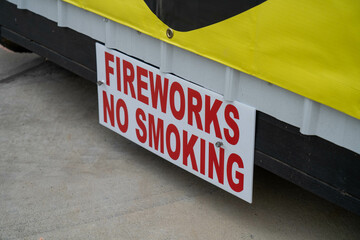 A warning sign on the side of a fireworks stand to prevent smoking in the vicinity.
