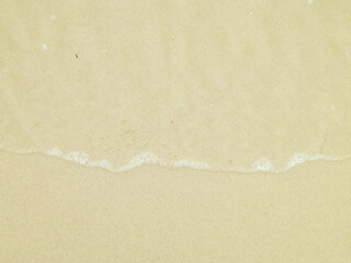 Sea water on sandy beach sand - nature background.