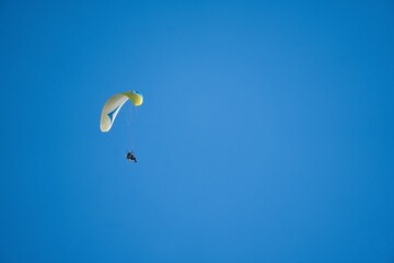 Embrace the Skies: Thrilling Paragliding Adventure in a Blue Sky