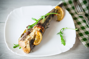 Baked fish with seasonings and spices in a plate