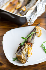 Baked fish with seasonings and spices in a plate