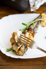 Baked fish with seasonings and spices in a plate