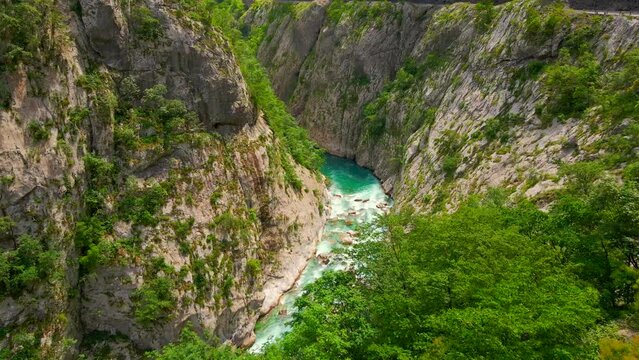 Aerial video of the stunning Moracha River canyon in Montenegro. Soar above the magnificent natural scenery, capturing stunning aerial views of the towering cliffs, crystal-clear river, and lush