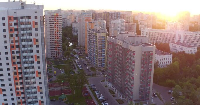 Drone flies over a new modern residential microdistrict in Moscow at sunset