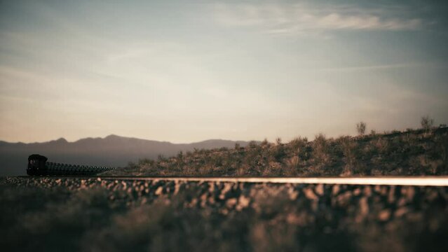 Military tanks on a railway train.  Transporting military vehicles through the desert. Military tanks transported by train