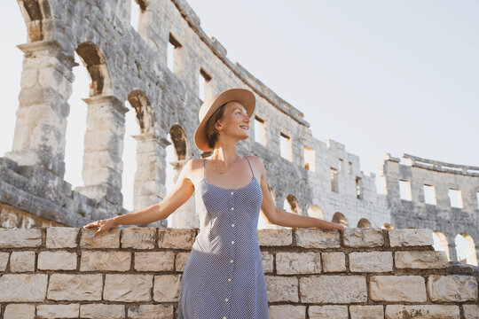 Beautiful tourist woman visiting the sights in Pula, Croatia. Vacation in Europe at summertime.
