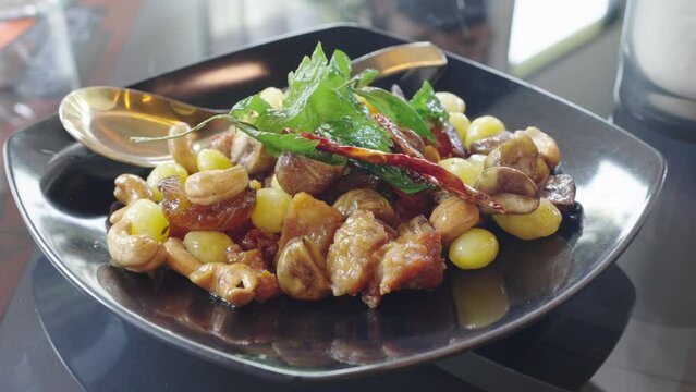 4k video, Stir fried mixed Chinese fruits and nuts - Asian food style. Pile of Stir and fried mixed Chinese fruits and ginkgo nuts serving on the plate. Famous ancient Chinese menu in restaurant.