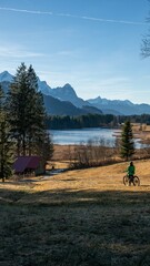 Biker girl near mountain lake