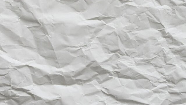 Wrinkled paper background texture. Looping sheets of paper as an abstract backdrop pattern. Empty space and a blank surface. Perfect for motion design or creative compositions.