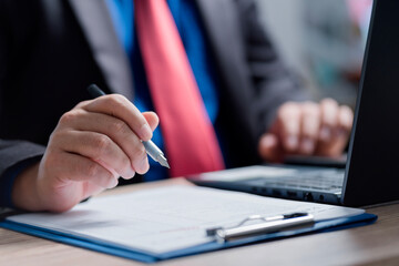 Businessman signing a document in office. business man signing contract making a deal,