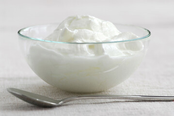 Fresh yogurt served in a clear glass bowl
