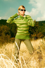 Young business woman relaxing on golden meadow at mountains outdoors