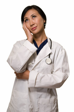 Attractive lady asian doctor in white lab coat with a stethoscope standing on white