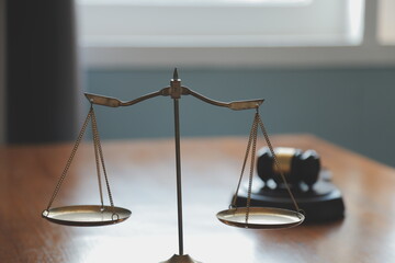 Business and lawyers discussing contract papers with brass scale on desk in office. Law, legal...