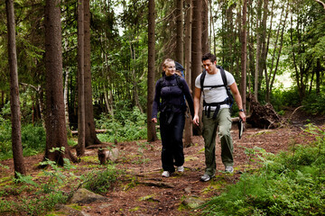 Fototapeta na wymiar A couple on a hiking camping trip in the forest