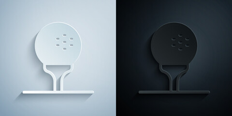 Paper cut Golf ball on tee icon isolated on grey and black background. Paper art style. Vector