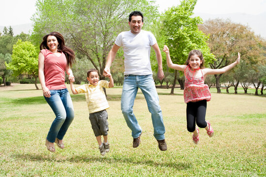 Family jumping together in the park,outdoor