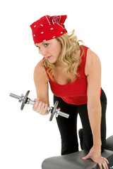 Caucasian woman in early 40s lifting weights using a dumbbell on a white background