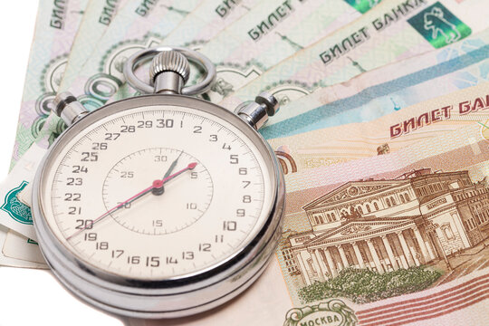 Time is money concept, stopwatch on Russian ruble banknotes