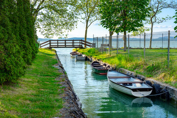 nice bridge with a small canal in Balatonbolar and fishng boats next to Lake Balaton