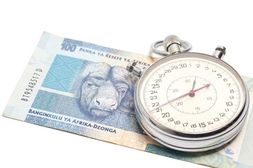 Time is money concept, stopwatch on South African money 100 rand banknote.