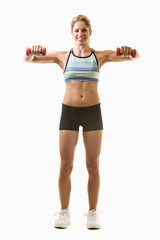 Full body of an attractive blond woman in great physical shape wearing black shorts and workout top standing on white with raised arms holding three pound weights