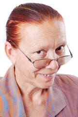 Middle aged woman is holding her glasses and smiling