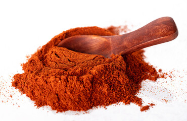 Wooden spoon on a paprika slide, isolated on a white background. General view