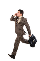 Business man running with a briefcase and speaking by phone, isolated over white background