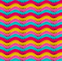 Seamless knitted pattern in the form of openwork waves is crocheted with threads of bright colors....