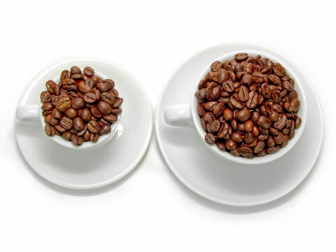 Coffee beans and two ceramic coffee mugs