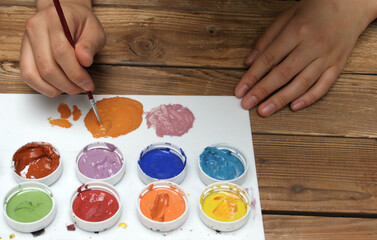 Close-up of artist mixing paint colors