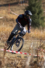 Black mountain biker on downhill race