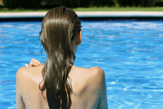 woman takes a sunbath in the swimming pool