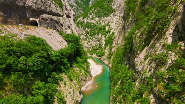 Aerial video of the stunning Moracha River canyon in Montenegro. Soar above the magnificent natural scenery, capturing stunning aerial views of the towering cliffs, crystal-clear river, and lush