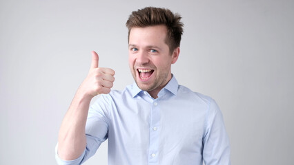 The European young man gives a thumbs up, approving the choice