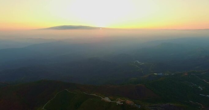 aerial view on the peak in sunset the village far from civilization Traveling on a difficult road..Beautiful sunset view on the hilltop complex..The sun shone through mountain peak after mountain..