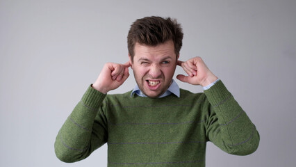 The European young man covers his ears. He doesn't want to hear the uncomfortable truth