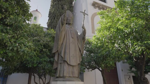Pope John Paul II statue in front of Catedral de Sevilla Santa Maria de la Sede Seville, Spain