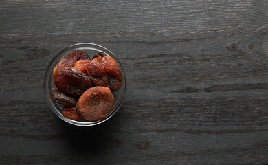 Dried apricots on a wooden background