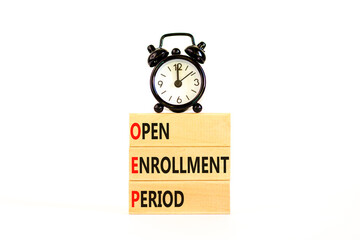 OEP symbol. Concept words OEP Open enrollment period on beautiful wooden block. Black alarm clock. Beautiful white table white background. Medical and OEP Open enrollment period concept. Copy space.