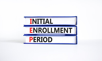 IEP symbol. Concept words IEP Initial enrollment period on beautiful books. Beautiful white table white background. Medical and IEP Initial enrollment period concept. Copy space.
