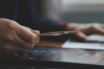 Women holding credit card and using smartphones at home.Online shopping, internet banking, store online, payment, spending money, e-commerce payment at the store, credit card, concept