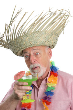 A senior on a tropical vacation, very excited about a margarita.