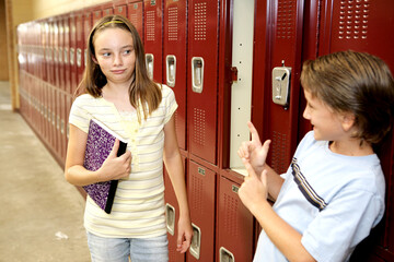 A humorous photo of a school girl reacting to a boy who is trying to flirt with her.